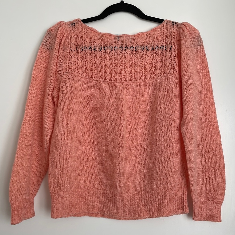 Pink sweater with crochet hearts